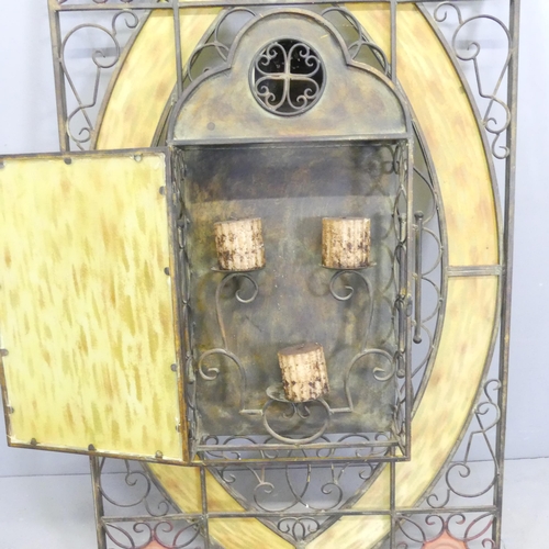 130 - A large wrought-iron and yellow stained glass candle stand wall panel, with allover pierced scrolled... 