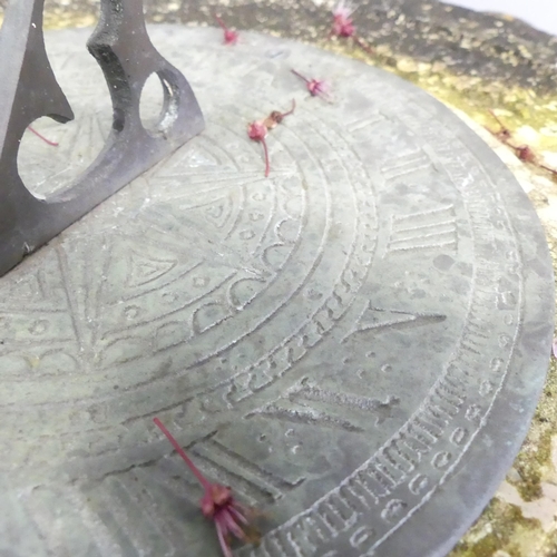 134 - A weathered stone two-section garden sun dial. 43x76cm.