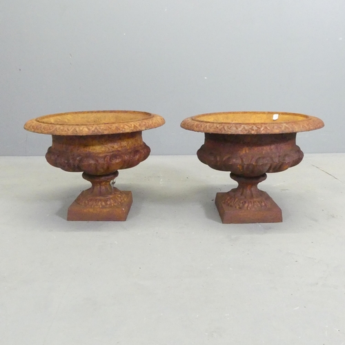 135 - A pair of small cast iron Campana style urns. 33x24cm.