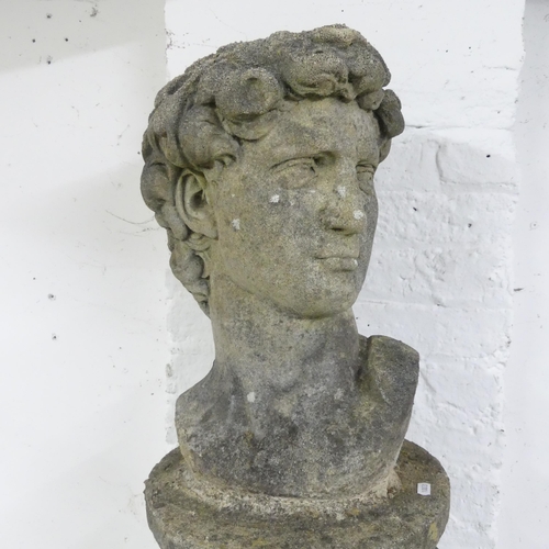 34 - A weathered concrete bust, study of David, on associated fluted pedestal. Height overall 127cm.