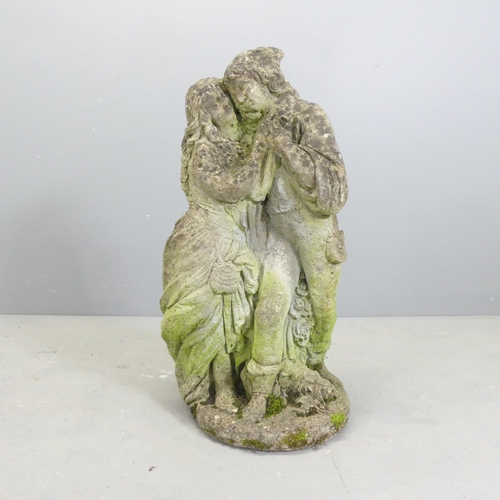 139 - A weathered stone garden statue, study of a dancing couple. Height 68cm.