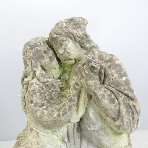 139 - A weathered stone garden statue, study of a dancing couple. Height 68cm.