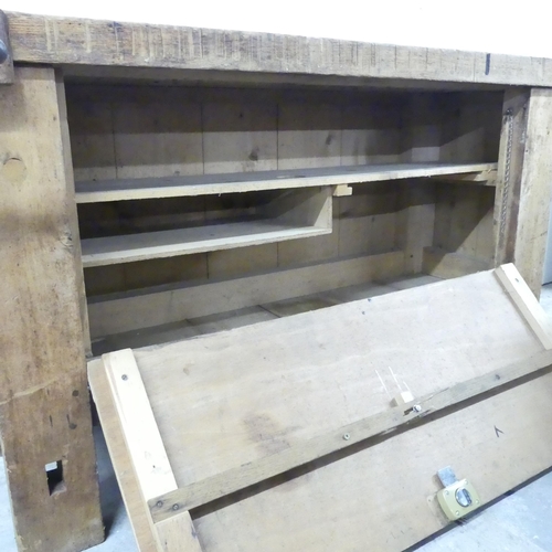 174 - A vintage pine workbench, fitted with vice and fall-front cupboard under. 197x78x58cm.