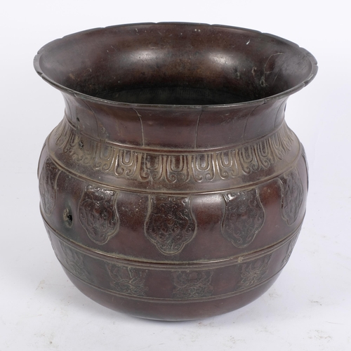 79 - An Indian embossed and engraved patinated brass vessel, with engraved and applied decoration, single... 