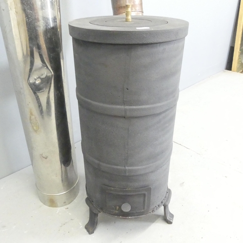 145 - A cast iron woodburning stove with metal chimney. Stove dimensions 26x59cm, chimney length approxima... 