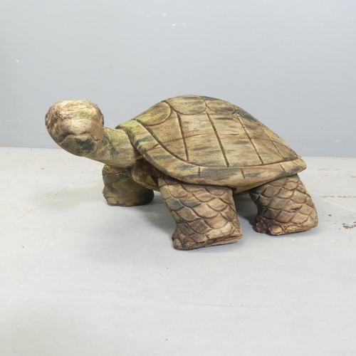 151 - A carved and weathered teak garden sculpture, study of a tortoise. Length 50cm.