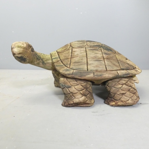 151 - A carved and weathered teak garden sculpture, study of a tortoise. Length 50cm.