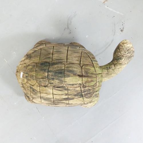 151 - A carved and weathered teak garden sculpture, study of a tortoise. Length 50cm.