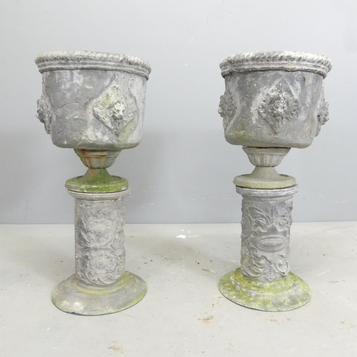 170 - A pair of 19th century lead urns on stands, with rope twist and lion mask decoration. 26x55cm.