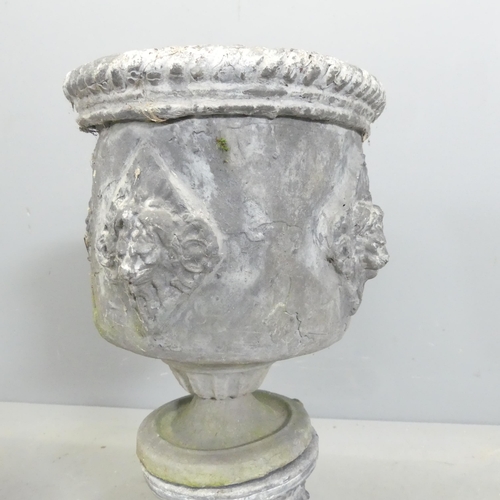 170 - A pair of 19th century lead urns on stands, with rope twist and lion mask decoration. 26x55cm.