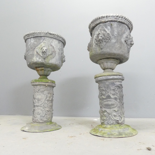 170 - A pair of 19th century lead urns on stands, with rope twist and lion mask decoration. 26x55cm.