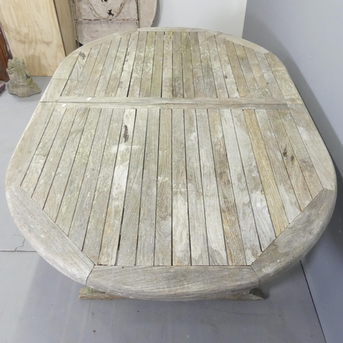 180 - BRAMBLECREST - A weathered teak draw-leaf extending garden table. 179x74x120cm (extending to 240cm).... 