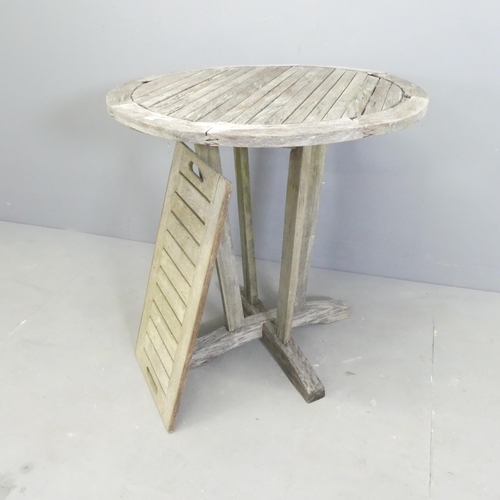 181 - BRAMBLECREST - A weathered teak circular garden table, 71x73cm, and a similar tray. (2)... 