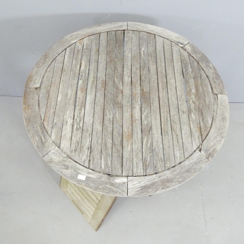 181 - BRAMBLECREST - A weathered teak circular garden table, 71x73cm, and a similar tray. (2)... 