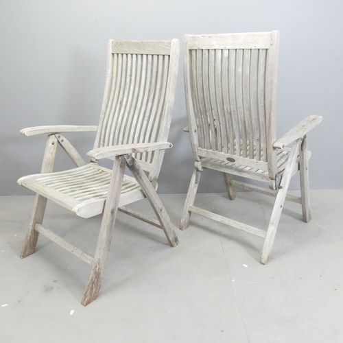 182 - BRAMBLECREST - A set of four weathered teak folding and reclining garden chairs. With maker's labels... 