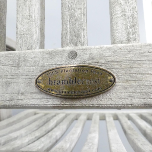 182 - BRAMBLECREST - A set of four weathered teak folding and reclining garden chairs. With maker's labels... 