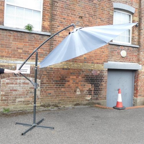 185 - A large banana garden parasol with metal base. Height 255cm.