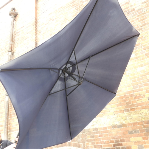 185 - A large banana garden parasol with metal base. Height 255cm.