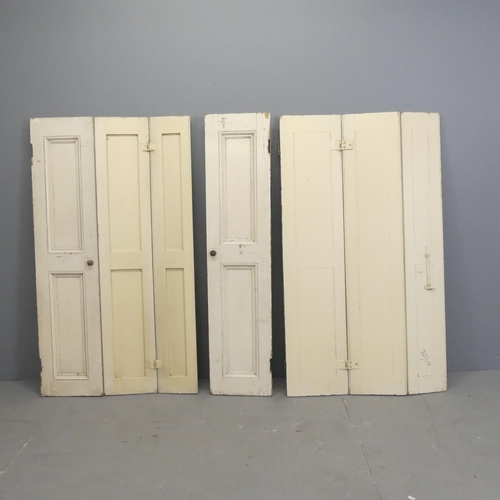 189 - Three antique panelled pine three-fold shutters. Each overall 70x123cm.