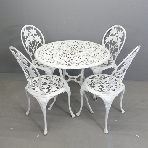 260 - A painted aluminium circular topped garden table with foliate design, 85x69cm, and four matching cha... 