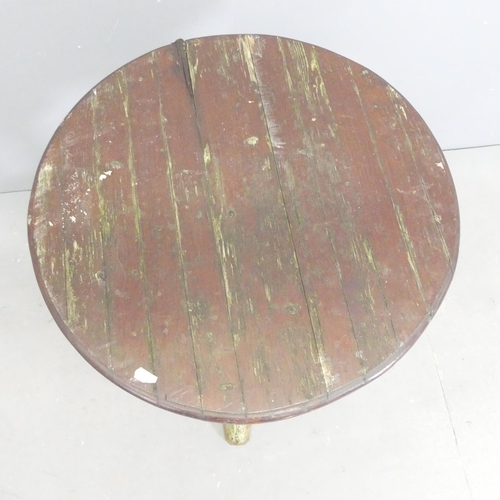 263 - A circular stained pine topped pub table on painted cast iron base., 55x70cm.