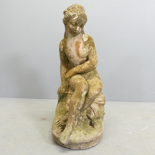 270 - A weathered stone garden statue, study of a nude seated lady. Height 59cm.