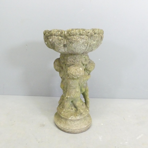 274 - A weathered concrete two-section bird bath, with cherub design base, 31x56cm.