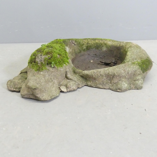 291 - A weathered concrete plant stand, in the form of a sleeping dog. 55x13cm.