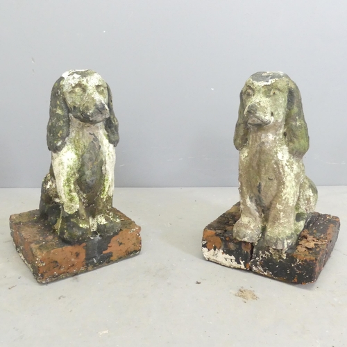 292 - A pair of weathered concrete garden dog ornaments on brick bases. Height 43cm.