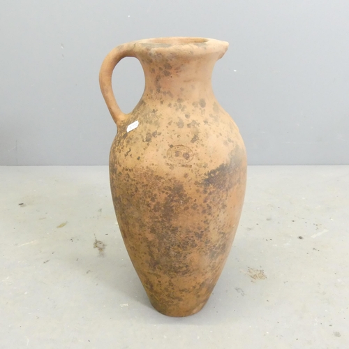 296 - A terracotta olive oil jar. Height 50cm.