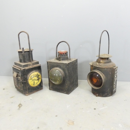 297 - Three vintage railway lanterns, including an Adlake non-sweating lamp, one marked BR(W) and one indi... 