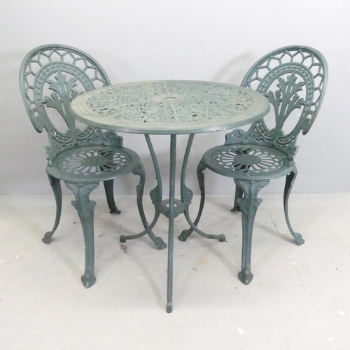 299 - A painted aluminium circular patio table, 69x72cm, with two matching chairs.