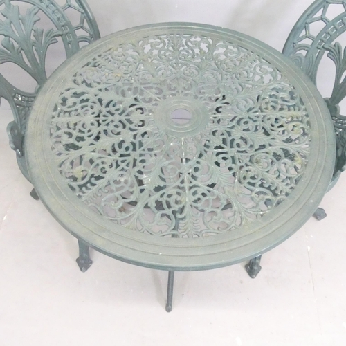 299 - A painted aluminium circular patio table, 69x72cm, with two matching chairs.