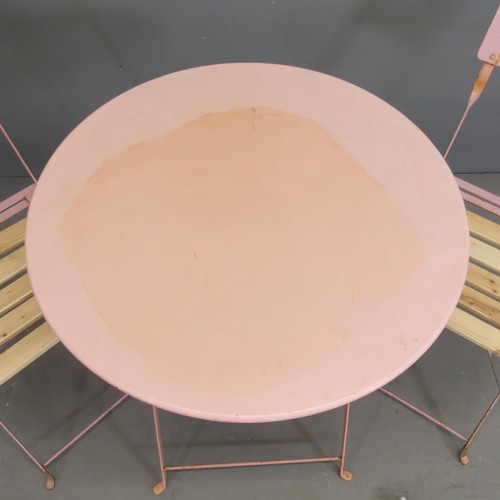 105 - A circular painted metal folding bistro table, 59x71cm, and two matching chairs.