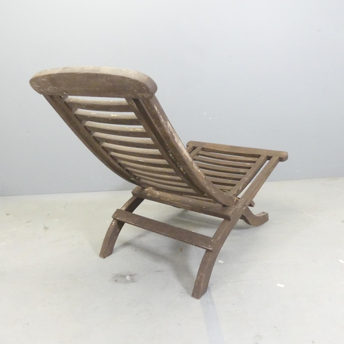 306 - A teak slatted folding sun lounger.