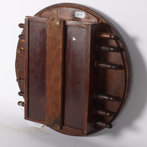 12 - An early 20th century stained wood circular perpetual wall calendar, diameter 30.5cm