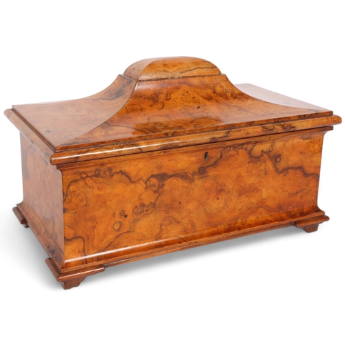 An early 19th century burr-walnut tea caddy of sarcophagus form, with fitted lidded boxes (no mixing bowl), on bracket feet, W37.5cm