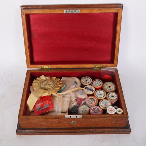 32 - A Victorian oak sewing box, with leaf and acorn relief carved hinged lid, and a quantity of various ... 