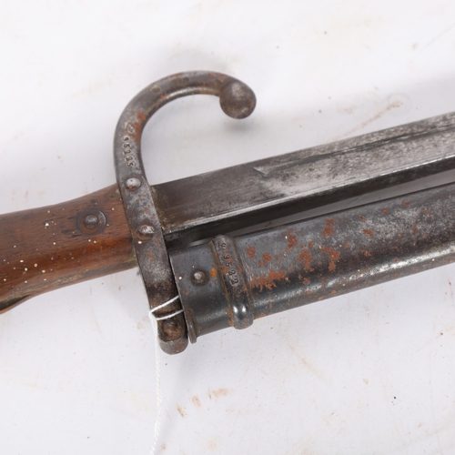 82 - A French military model 1874 bayonet and scabbard, serial no. 95225 to the hilt and scabbard, blade ... 