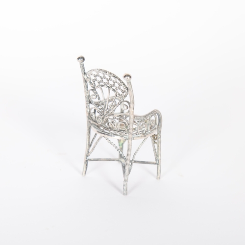 230 - A Continental miniature silver doll's armchair, apparently unmarked, 6cm