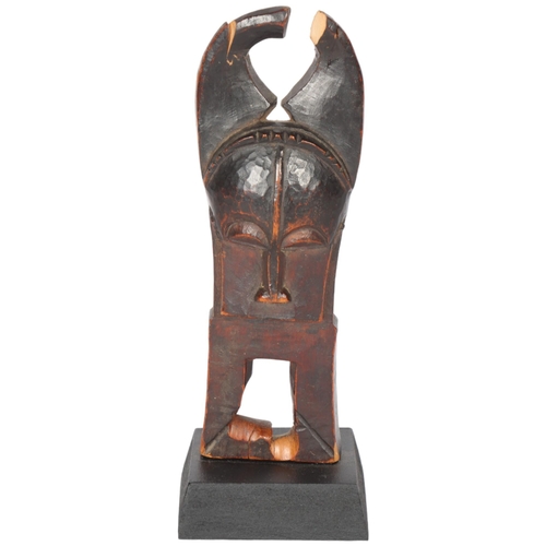 235 - A Baule, Ivory Coast weaving pulley, carved wood masked figure on wooden plinth, height 16cm