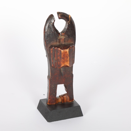 235 - A Baule, Ivory Coast weaving pulley, carved wood masked figure on wooden plinth, height 16cm