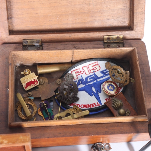 287 - A Royal Indian Army Service Corps teak box, with engraved crest, a quantity of various military badg... 