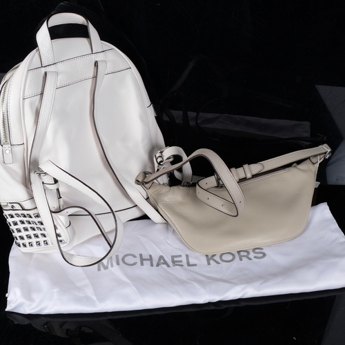 300 - A Michael Kors light grey leather bumbag, with metal studded detail, and a Michael Kors white leathe... 