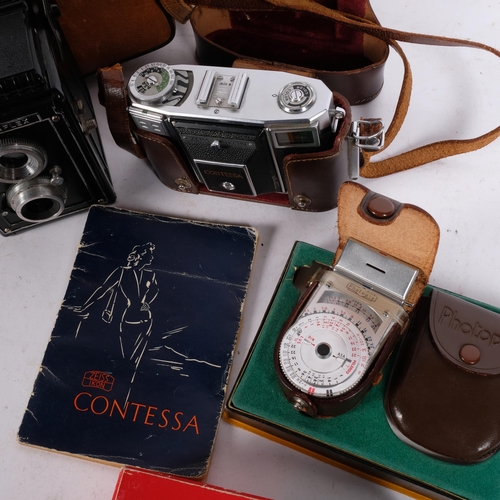 331 - A Zeiss Ikon Contessa camera, and associated booklet regarding the use of this camera, a Photopia ex... 