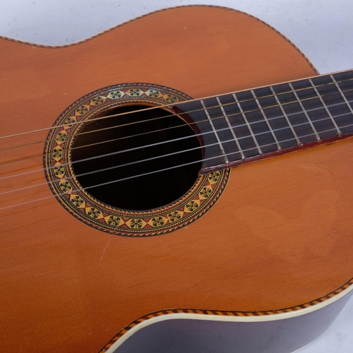 358 - A Vintage Romy Lumanog acoustic guitar, with inlaid decoration