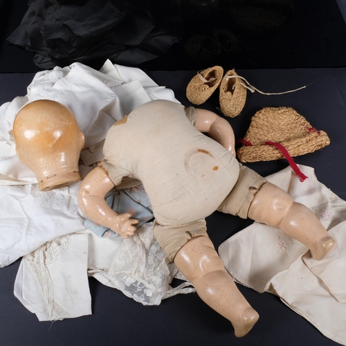 783 - A Horsman composition doll, with soft body and composition limbs, circa 1920s, and 24 outfits