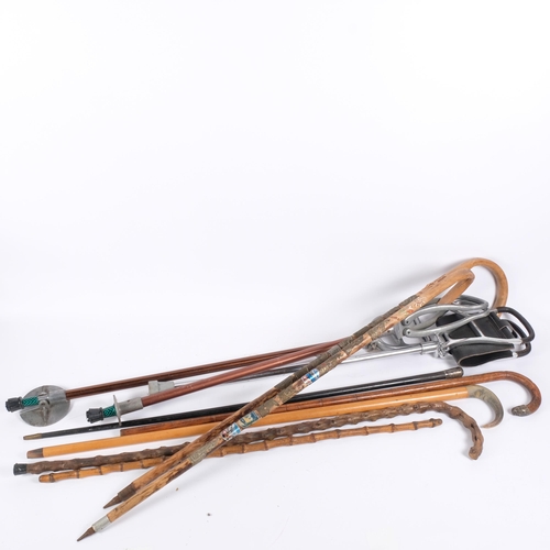 130 - A group of various walking sticks, including an ebony and silver-mounted example, 3 shooting sticks,... 