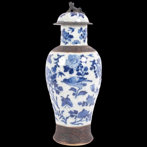 161 - A Chinese blue and white crackle glaze jar and cover with bird and floral decoration, and dog of fo ... 