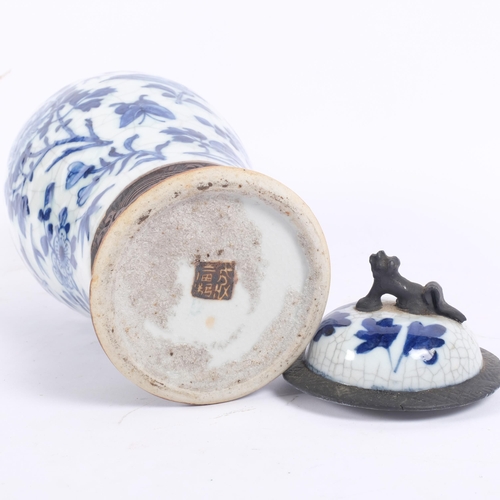 161 - A Chinese blue and white crackle glaze jar and cover with bird and floral decoration, and dog of fo ... 